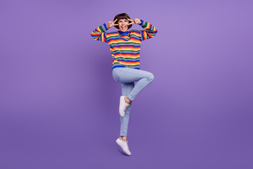 Canvas Print - Photo of positive crazy lady jump show v-sign near eye wear striped sweater jeans shoes isolated purple color background