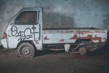 Side View Of An Old Abandoned Truck Left In A Garage