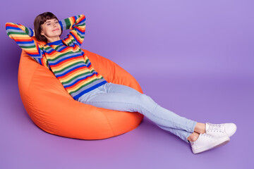 Sticker - Photo of positive inspired lady sit beanbag enjoy break nap wear striped sweater isolated violet color background