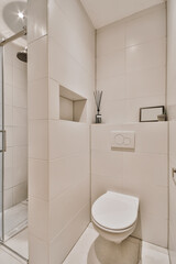 Poster - Minimalist interior of a toilet with light tiles