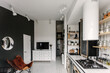 © Luciano Spinelli/Stocksy - Living room with a leather chair in black and white flat