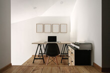 Minimalist Home Office With White Frames On The Wall