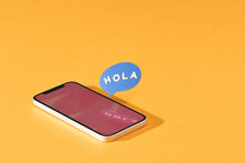 Hola, Mobile Phone With Words Hola In Text Bubble