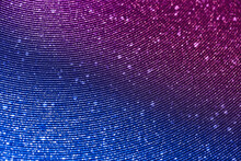 Wavy Shimmering Blue Background. Texture With Grain And Purple Sequins Close-up. Gradient Two-color Image