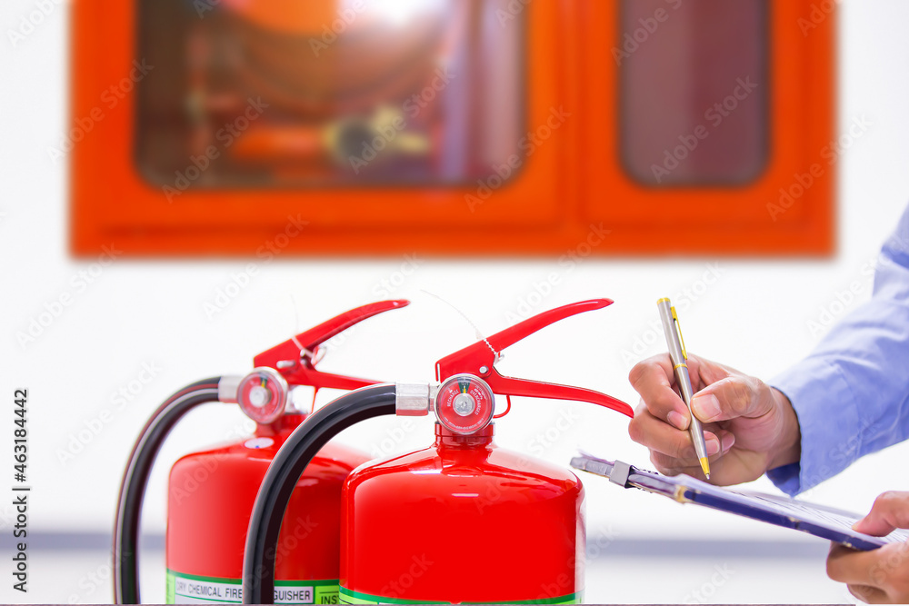 Fire Engineers Testing Fire extinguisher, Engineer inspection checking pressure gauge level ...