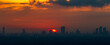 © bangprik - The blurred abstract background of the morning sun exposure to the tiny dust particles that surround the tall buildings in the capital, the long-term health issue of pollution.