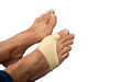 A middle age woman feet have bunion bent toe problem wearing foot support on treatment for bent toe problem and help to protect the toe from discomfort, pressure and inflammation caused by bunion. 