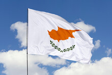 Cyprus Flag Isolated On The Blue Sky Background. Close Up Waving Flag Of Cyprus. Flag Symbols Of Cyprus. Concept Of Cyprus.