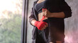 A female boxer wrapped a boxing cloth on both hands.