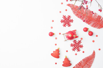 Wall Mural - Flat lay christmas frame with red berries, snowflakes and red balls on a white background. Merry christmas card and copy space for your text