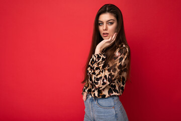 Wall Mural - Close-up portrait of young nice-looking attractive lovely glamorous brunet woman wearing leopard blouse isolated on red color background with free space