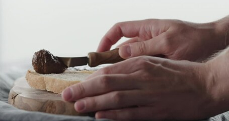 Wall Mural - Slow motion man spread chocolate nut cream on ciabatta slice