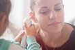 © fabio - little baby girl measures the temperature to the mother with ear thermometer