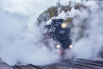 Wall Mural - Retro steam train departs from the station wooden platform.