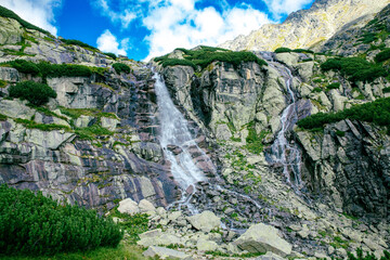 Wall Mural - Panoramic view of Skok waterfall and the lake in the western part of High Tatras, Slovakia