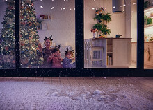 Cute Kids Watching The Snow Flakes Falling On The Patio At Magical Chrismas Night, Cozy Winter Holidays