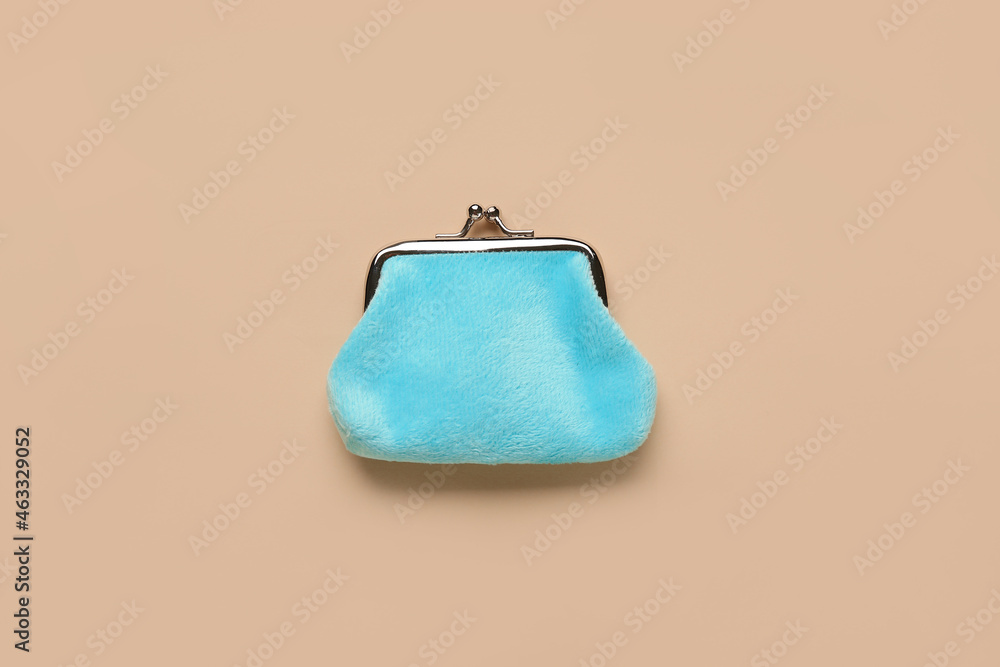 Blue wallet on beige background