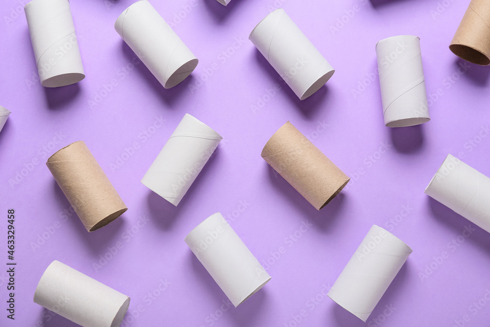 Toilet paper cardboard tubes on purple background