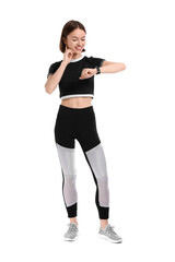 Wall Mural - Sporty young woman checking pulse on white background