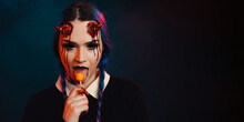 Woman With Scary Halloween Makeup With Bloody Horns Dark Background