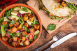 Vegetarian balanced diet concept with vegetable proteins - vegetable salad with avocado, arugula and fried tofu, tacos with vegetables and tofu on the table, top view