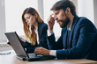 © SHOTPRIME STUDIO - colleagues sitting at a desk with a laptop communication finance officials
