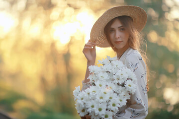 Wall Mural - happy romantic girl in a straw hat / young model in a dress summer day, happiness woman