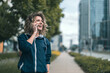 © pikselstock - Young woman using mobile phone in the city