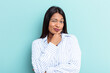 © Asier - Young Venezuelan woman isolated on blue background looking sideways with doubtful and skeptical expression.
