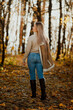 © KseniyaK - a blonde adult girl walks in the autumn forest. a walk in the fresh air alone
