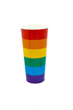 Paper cup painted as a rainbow on a white background. Coloring LGBT symbol concept or celebratory drink in cafe. Isolate Copy space