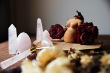 Still Life With A Clay Figure Of A Pregnant Woman Decorated With Dried Roses And Various Rose Quartz Crystals (egg, Rose Quartz Face Roller)