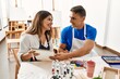© Krakenimages.com - Two students smiling happy painting sitting on the table at art school.