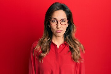 Sticker - Young latin woman wearing casual clothes and glasses depressed and worry for distress, crying angry and afraid. sad expression.