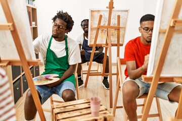 Sticker - Group of young african american artist man smiling happy drawing at art studio.