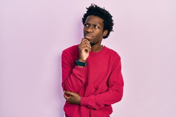 Poster - Young african american man wearing casual clothes with hand on chin thinking about question, pensive expression. smiling with thoughtful face. doubt concept.