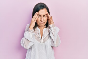 Poster - Middle age hispanic woman wearing casual clothes with hand on head for pain in head because stress. suffering migraine.