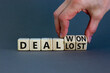 © Dzmitry - Deal lost or won symbol. Businessman turns wooden cubes and changes words 'deal lost' to 'deal won'. Beautiful grey background, copy space. Business and deal lost or won concept.
