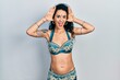 © Krakenimages.com - Young woman wearing bindi and traditional belly dance clothes smiling cheerful playing peek a boo with hands showing face. surprised and exited