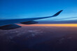 Beautiful panoramic view from inside the airplane during sunset, wing close-up. Switzerland, Zurich Airport