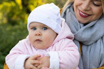 Wall Mural - Happy beautiful mother spending time with her little baby girl in nature.