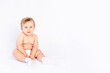 baby six months old in diapers on white isolated background, space for text