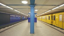 Metro Subway Station In Berlin. U-Bahn Is An Underground Metro In Germany. Yellow Train At Platform.