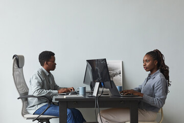 Wall Mural - minimal side view portrait of two african-american young people using computers and writing code whi