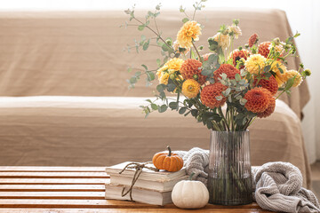 Autumn background with a bouquet of chrysanthemums and pumpkins, copy space.