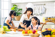© Art_Photo - Portrait of enjoy happy love asian family mother and little asian girl daughter child having fun help cooking food healthy eat together with fresh vegetable salad and sandwich ingredient in kitchen