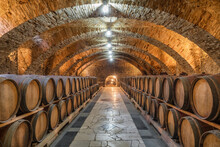 Old Wooden Barrels With Wine In The Ancient Medieval Cellars