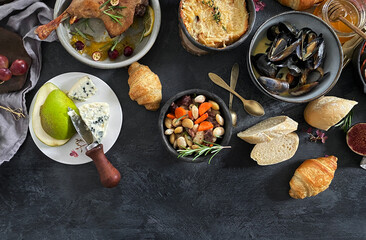 Wall Mural - French dishes and appetizers served on dark background.