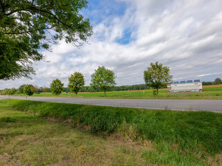 Canvas Print - Landscape of empty highway road under a cloudy sky in the countryside