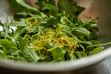 Canvas Print - Salad with arugula and orange zest in metal bowl